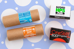 Sample film bundle.  Four random rolls of film on a blue background.  Brands shown are Cute Camera Co, CineStill, Ilford.