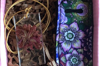 The All Things Florally Box features 2-3 items depending on the size of each product. Items featured include 1 necklace and 1 chap stick bag