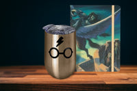 A Harry Potter Wine Tumbler with Harry's Glasses and Lightning Bolt Scar and a Harry Potter Journal.
