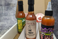 SCOVILLED hot sauce subscription box featuring Up All Night Bottling Co., Grand Traverse Sauce co., and Sam Sa'house