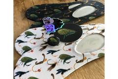 Close up of the fly fishing socks, stickers, and pin.  Perfect for the fishing woman or man, or couple.