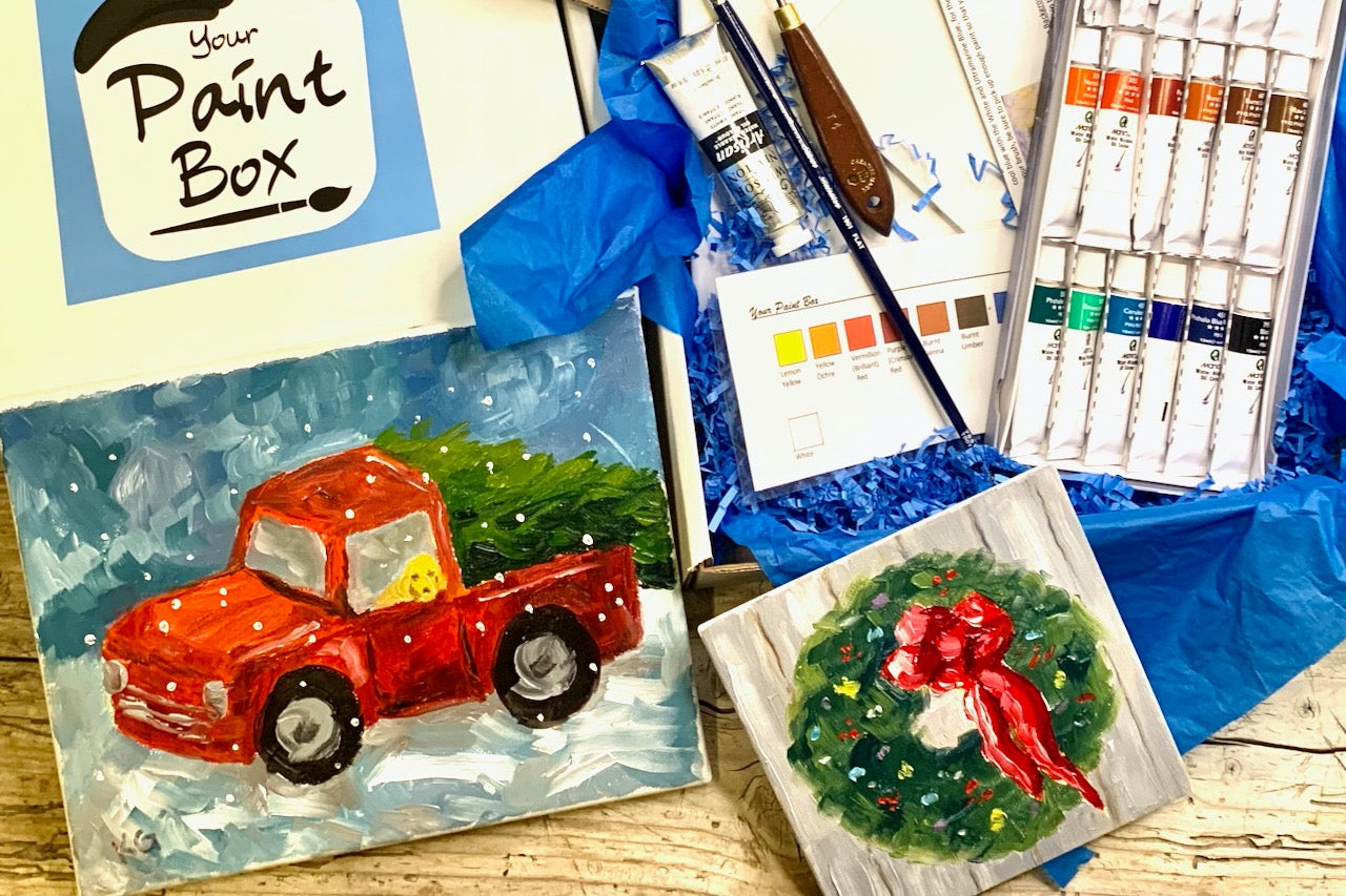 A painting lesson in a box. Painting project is red truck with Christmas tree and a small evergreen wreath painting. Supplies included