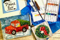 A painting lesson in a box. Painting project is red truck with Christmas tree and a small evergreen wreath painting. Supplies included