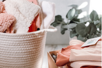 Items from a Baby and Sunshine subscription box including Soft and comfy clothes for babies and for mom.