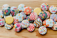 Spring 2023:  Seventies  theme one inch buttons in many beautiful and cheery colors and flower  patterns. 