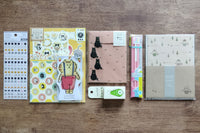 Packs by Misty Co. stationery subscription bundles with scrap booking pack, deco tape, 3pk pencil set, stickers, letter sets and memo pad.