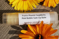1 Natural, homemade lip balm, Pink Bubble Gum. Surrounded by calendula flowers. Picture taken in my back yard.