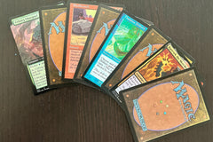 Assortment of curated rare cards and Magic: The Gathering cards from throughout Magic history against a dark background