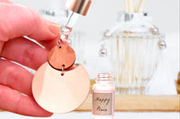Photo Example of How to Apply Mini Essential Oil Dropper to Diffuser Earring Backs by Greenmade goods
