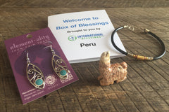 Peru Box of Blessings filled with cabochon Earrings , a carved llama, and a 3 metal leather bracelet.