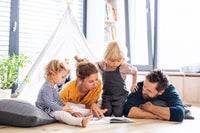 Three colorful children's books from the Kids Read Daily Book Club: "My Family and Me," "The Thrifty Guide to Ancient Rome," and "Freddie Mole, Lion Tamer"