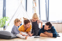 Three colorful children's books from the Kids Read Daily Book Club: "My Family and Me," "The Thrifty Guide to Ancient Rome," and "Freddie Mole, Lion Tamer"