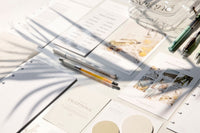 Items from a Cloth and Paper subscription box including papers, stationary, and pens all laid out neatly.