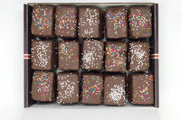 Nettie's Craft Brownies rainbow cookies sprinkles chocolate dipped aerial view of fifteen cookies in box.
