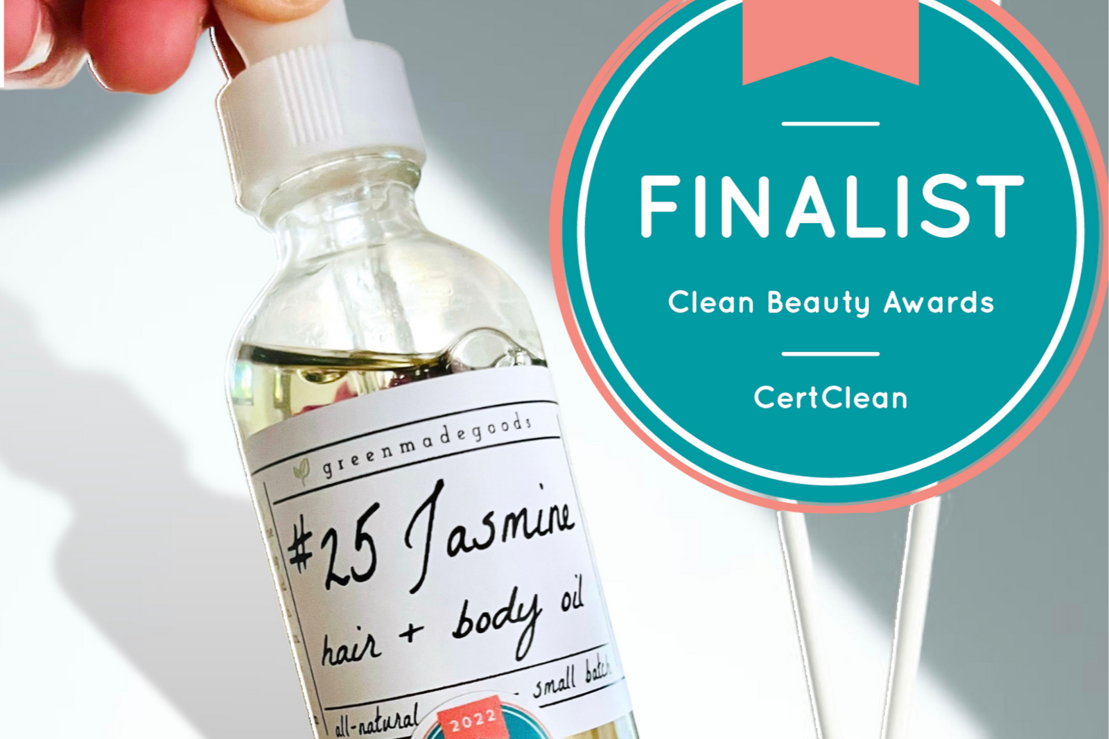 The Jasmine Hair + Body Oil by Greenmade goods with the Clean Beauty Award Seal in the right hand corner.