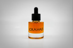 Amber bottle of LOKA.HAUS's 'Duality Facial Oil'. A radiant glow captured in elegant packaging. Pure beauty in every drop.