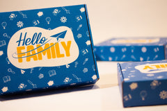 Signature blue Hello Family box with logo and multiple doodles featuring Hello Family characters and activities.