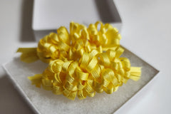 Yellow ruffle bows make you smile at the sight of them. Delightful as a sunny day. Perfect for spring summer, and fall!