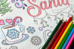 Coloring page with a cup of cocoa that has a snowflake on the mug colored in blue. Peppermint cane sticking out for stirring. Santa in red.