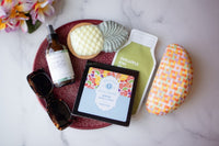 A vibrant display of summer-themed self-care items. All are arranged aesthetically against a sunny backdrop.