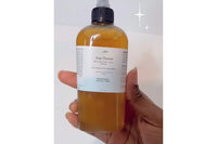 a close up of Mellow Melanin's Moisturizing Scalp Serum, one of the products included in Her Crown and Glory's 2023 Winter Loc Box 