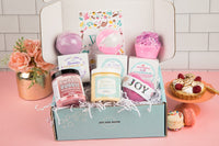 Treat Yourself Bath Bevy Subscription box with bath bombs, whipped soap scrub, bubble rubble with flowers and pastries