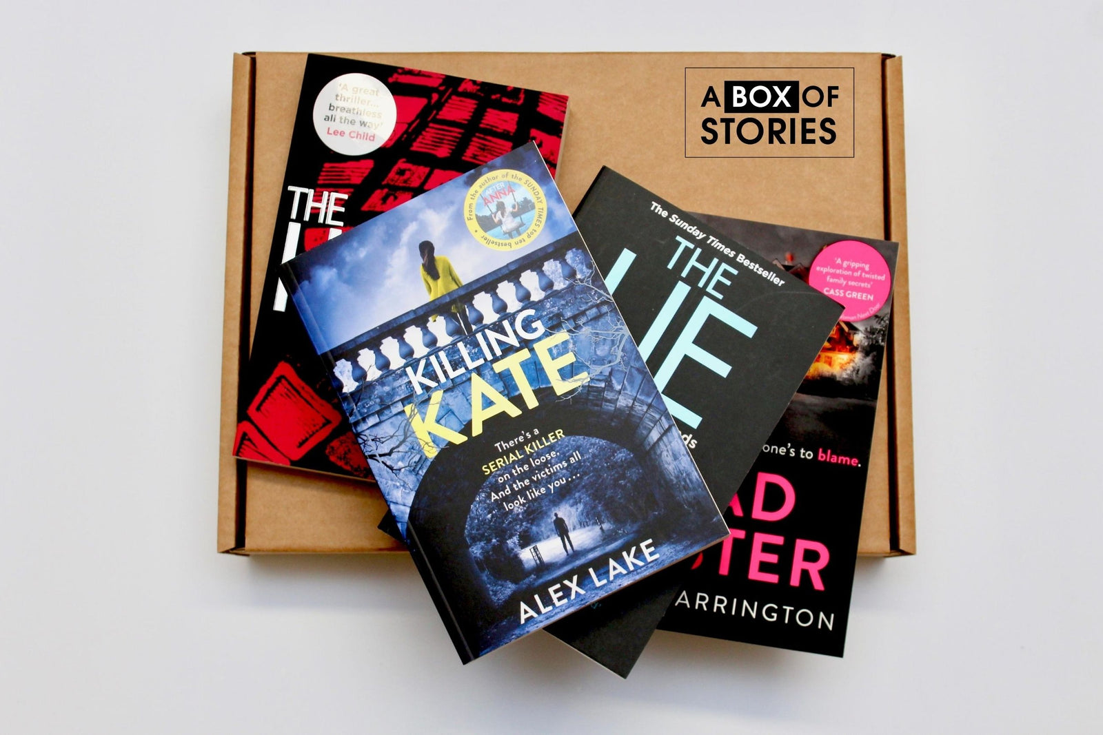 Brown subscription box filled with four surprise mystery books, featuring captivating stories and intriguing plots for genre enthusiasts.