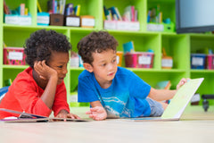 Three colorful children's books from the Kids Read Daily Book Club: "My Family and Me," "The Thrifty Guide to Ancient Rome," and "Freddie Mole, Lion Tamer"