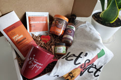 Valentine's Day spicy food box filled with hot sauce, crunchy chili oil, spicy chocolate, creamed spicy honey, mug and t-shirt.