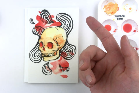 SketchBox subscription box featuring art supplies like markers, a notebook, and a brush for creative projects