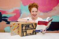 Owl Post Books YA Imagination Box. Three new hardcover books delivered monthly. Picture shows woman smiling with box and books.