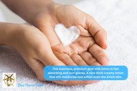 Outstretched hands with a heart shaped goat milk lotion smear on their palm to show the thick rich texture of the lotion.