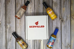 SCOVILLED subscription box featuring Grand Traverse Sauce Co., Bravado Spice Co., Karma Sauce, and Angry Goat Pepper Co.