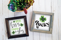 Brown and gray wood framed signs in various designs. St. Patrick's day irish kisses and shamrock wishes, lucky designs.