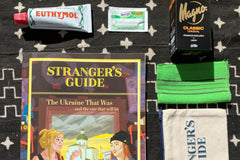 Euthymol toothpaste, Mango soap, a Stranger's Guide bath case, Picot antacid, a South Korean "Italy" towel and Strangers Guide: Ukraine