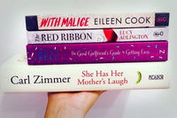 Brown subscription box filled with four surprise fiction books, offering captivating stories and diverse plots for literature lovers.