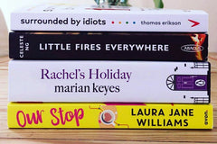 Brown subscription box filled with four surprise fiction books, offering captivating stories and diverse plots for literature lovers.