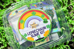 Leprechaun slime kit from Bored to Brilliant in a clear deli container with glitter and clay pieces, slime activator, jello powder.