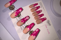 Set name: Heart Beat. French tip nails with nude base and hot pink french tip with hearts and start gel design.