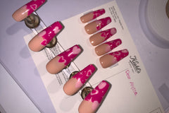 Set name: Heart Beat. French tip nails with nude base and hot pink french tip with hearts and start gel design.