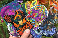 Colorful assortment of stickers from the Monthly Sticker Savages Box featuring monsters and whimsical designs for water bottle stickers