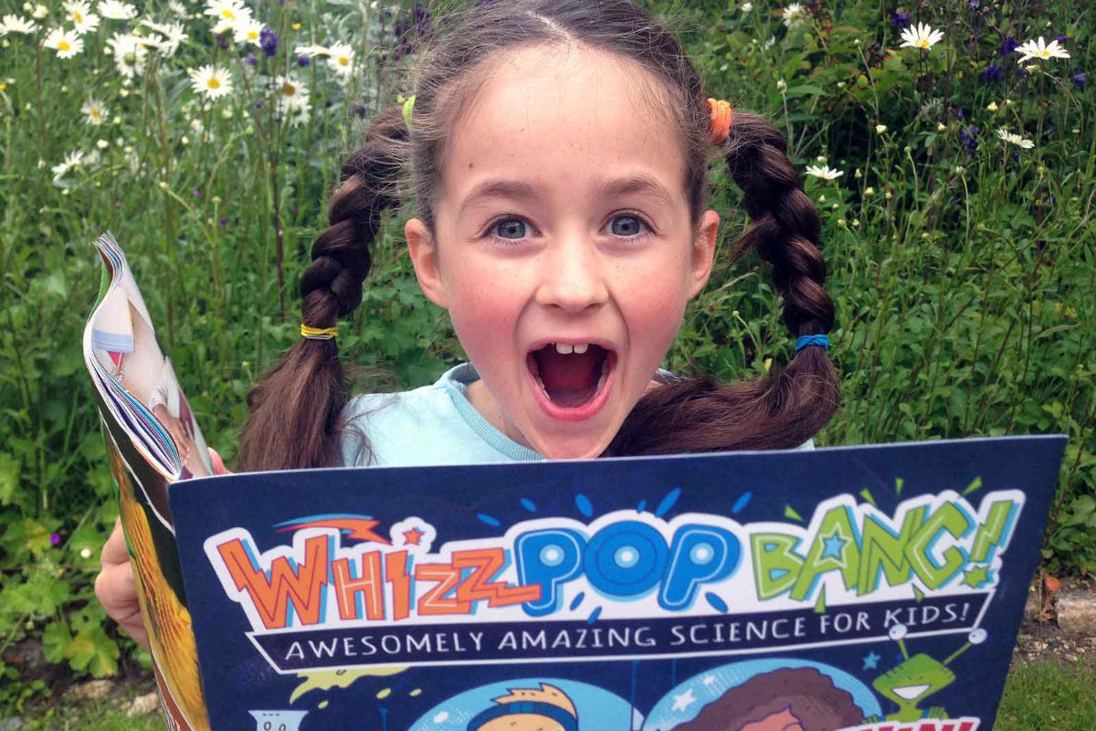 Girl reading Whizz Pop Bang magazine – the awesome science magazine for kids aged 6 to 12 – experiments, crafts, puzzles, jokes and more