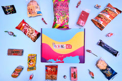 The Pachanga Box featuring snacks all around the box. They are all snacks from the El Salvador theme. 