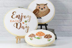 three counted cross stitch patterns of autumn owl, mushrooms and inspirational words in this subscription box