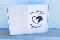 Image showing top of The Stable Box - a white box with heart and horse logo. Love for you and your horse. 