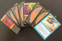 Assortment of curated rare cards and Magic: The Gathering cards from throughout Magic history against a dark background