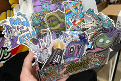 Colorful assortment of stickers from the Monthly Sticker Savages Box featuring monsters and whimsical designs for water bottle stickers