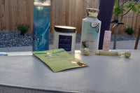 various bath and body works products, jade roller, peel of mask and bath and body works gigham candle.