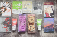 Items from Romance Is A Book subscription box including manga books, headbands, hand lotion and face masks.
