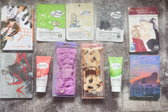 Items from Romance Is A Book subscription box including manga books, headbands, hand lotion and face masks.